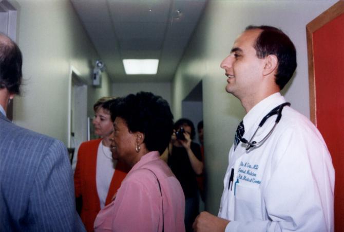 Staff members gather in the hallway