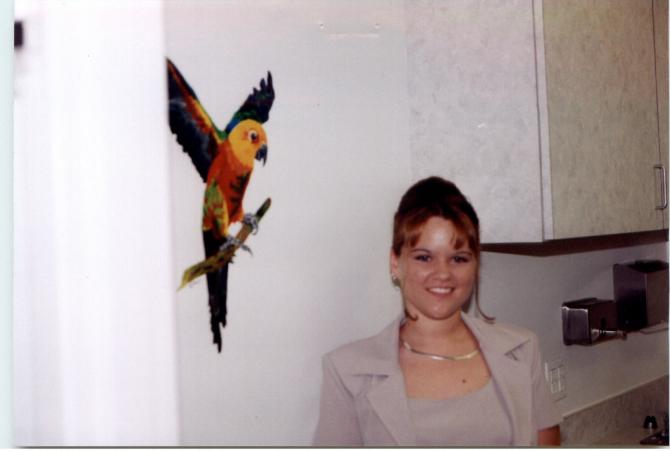 Staff woman with parrot mural