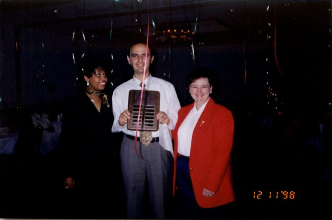 Staff members with plaque