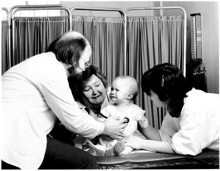 Dr. Paul Gustafson and staff with young patient