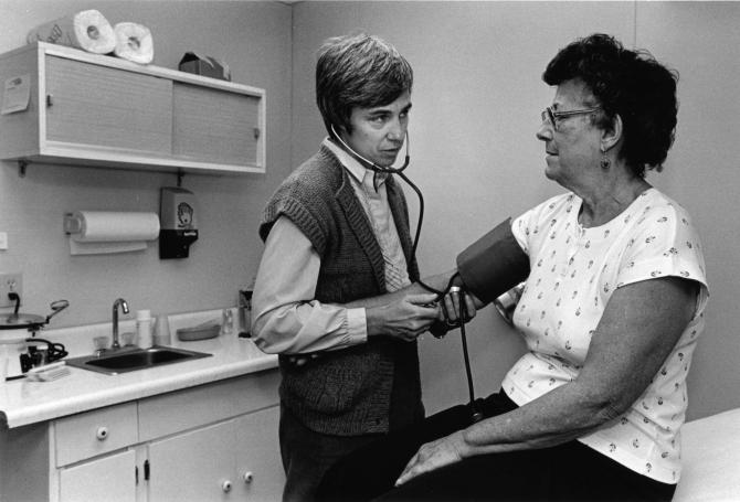 A patient has her blood pressure checked