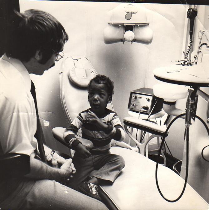 A young patient speaks with the dentist