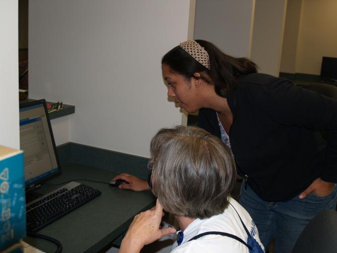 Two staff members on the computer