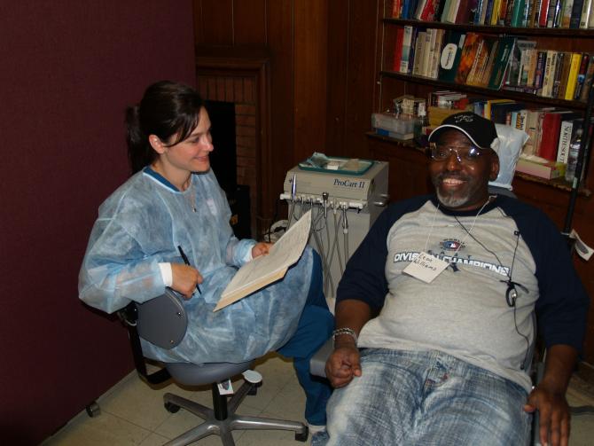 Staff member and patient at the dental clinic