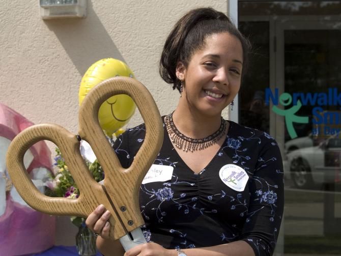 Staff member with ceremonial scissors