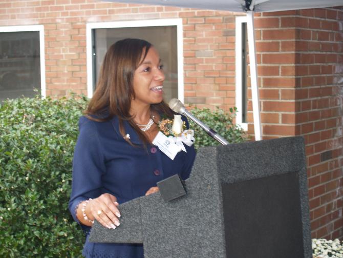 Woman speaking at Mary Lou Strom opening