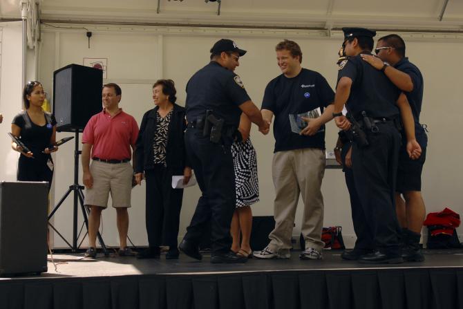 Police men being honored on stage