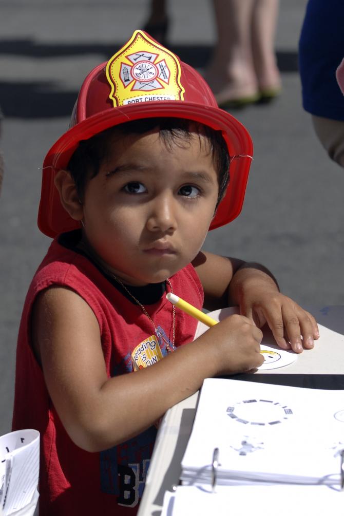 A boy coloring during the festivities