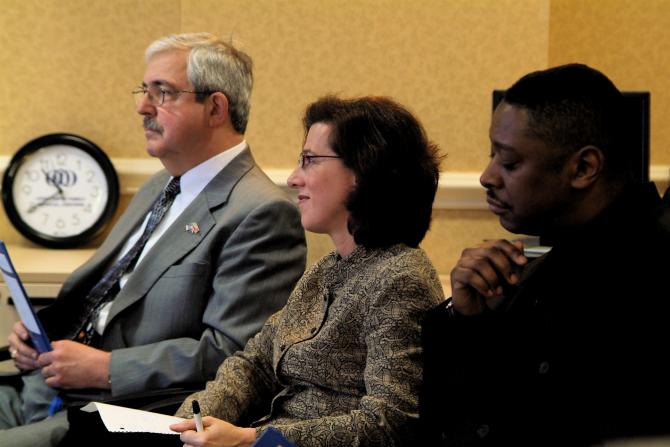 Lindsay Farrell and others listen to speakers