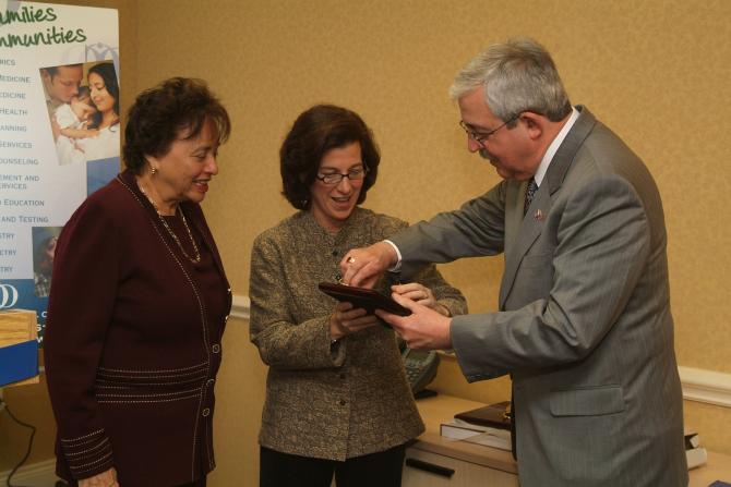 Lindsay Farrell receiving a plaque