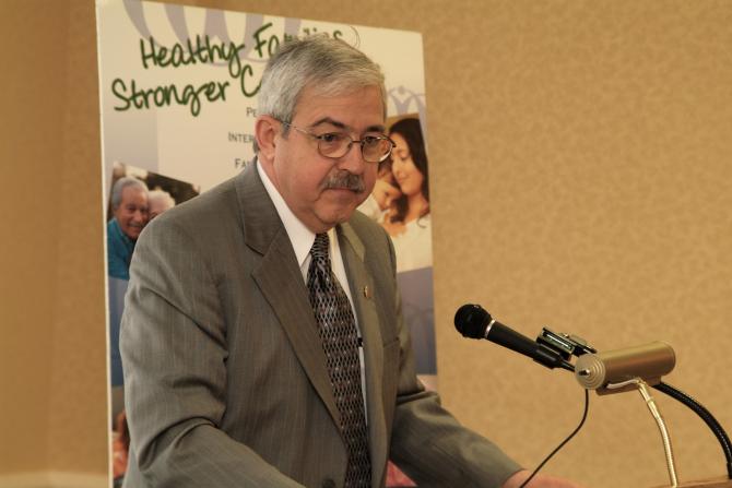 An Open Door Staff Member speaking at the podium