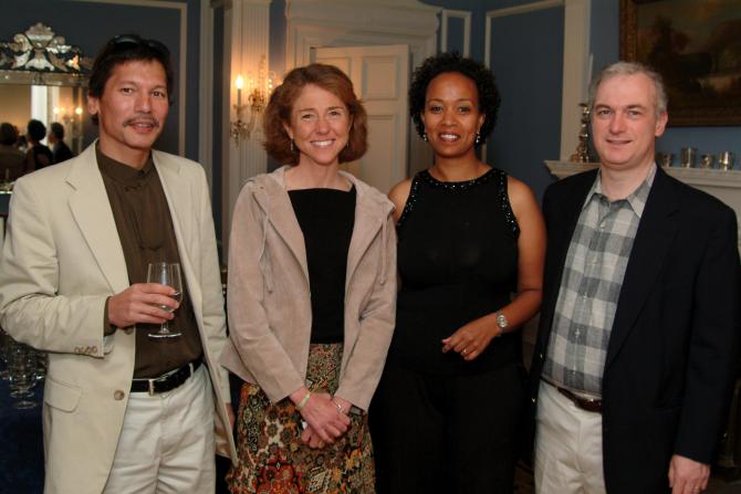 Four people in front of the fire place