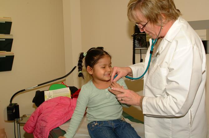 Physician examining young girl