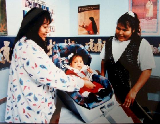 RN Rhoda Scott with baby and mother