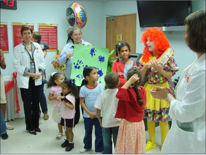Children partake in a group activity with a clown