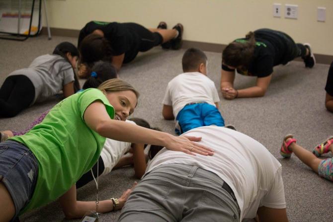 Participants learning a 7 minute workout from Campeones de Salud