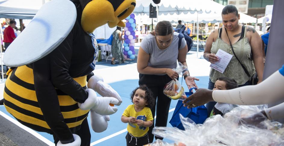 UHP mascot with young visitor at WIC Breastfeeding Expo 2019 (Bronx, NY). Photo by Romina Hendlin.